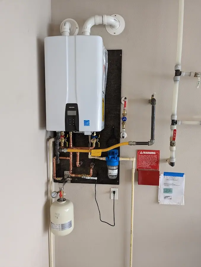 Professional plumber installing copper piping in a Goulds home